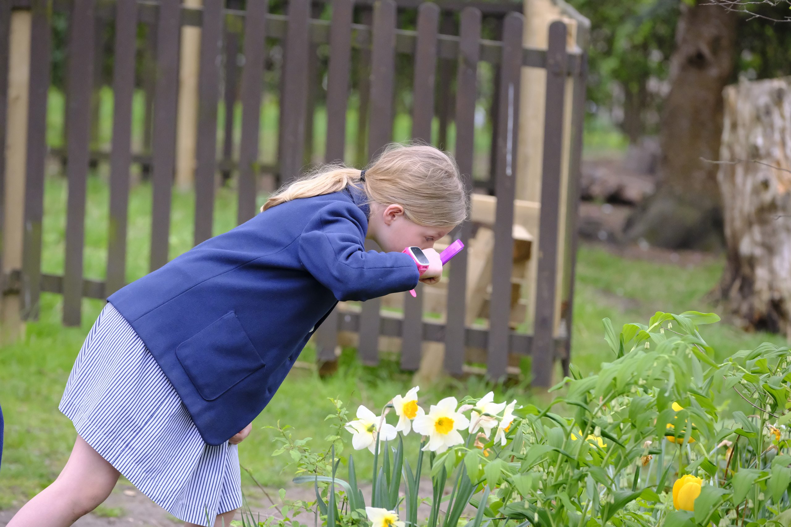 a girl looking at flowers