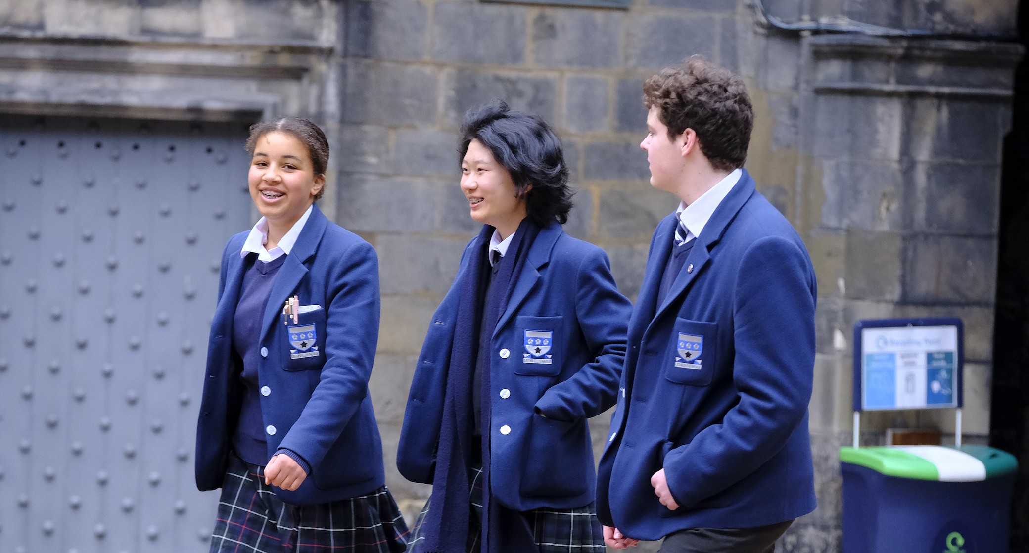 3 students walking and laughing